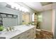 Bathroom features a double sink, marble countertop, large mirror and storage at 150 Sandy Ridge Trl, Fayetteville, GA 30214