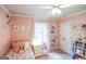 Inviting pink bedroom highlighting a bright window with curtains and colorful decor at 150 Sandy Ridge Trl, Fayetteville, GA 30214