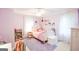 Bright bedroom with ceiling fan, and warm hardwood flooring, with pastel decor at 150 Sandy Ridge Trl, Fayetteville, GA 30214