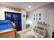 Fun bedroom with a study desk, a closet, and superhero-themed decorations at 150 Sandy Ridge Trl, Fayetteville, GA 30214