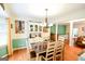 Bright dining room with hardwood floors, stylish chandelier, and staircase view at 150 Sandy Ridge Trl, Fayetteville, GA 30214