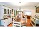 Beautiful dining room with wood floors, modern light fixture, and view to living area at 150 Sandy Ridge Trl, Fayetteville, GA 30214