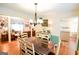 Dining room with hardwood floors, elegant lighting, and view into living room at 150 Sandy Ridge Trl, Fayetteville, GA 30214