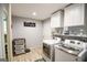 Bright laundry room features modern machines, storage cabinets, and stylish decor at 150 Sandy Ridge Trl, Fayetteville, GA 30214