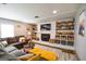 Cozy living room has stone fireplace with built-in shelving, and hardwood flooring at 150 Sandy Ridge Trl, Fayetteville, GA 30214