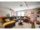 Spacious living area includes ceiling fan, and large sofa, perfect for entertaining at 150 Sandy Ridge Trl, Fayetteville, GA 30214