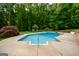 Sparkling backyard pool with surrounding patio area, a gazebo, and lush landscaping, perfect for summer fun at 150 Sandy Ridge Trl, Fayetteville, GA 30214