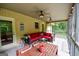 Relaxing screened porch with brick accents, ceiling fans, and comfortable seating area for entertaining at 150 Sandy Ridge Trl, Fayetteville, GA 30214