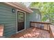 Charming home featuring a wooden deck, an AC unit, and a door leading to the exterior at 3404 Broxton Mill Way, Snellville, GA 30039