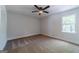 Bedroom with natural light, neutral carpeting, and closet with louvered doors at 3404 Broxton Mill Way, Snellville, GA 30039