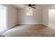 A bright bedroom featuring wood-look flooring, ceiling fan, and natural light from a window at 3404 Broxton Mill Way, Snellville, GA 30039