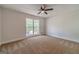 Bedroom with large window providing natural light and neutral-toned carpeting at 3404 Broxton Mill Way, Snellville, GA 30039