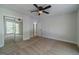Bedroom featuring neutral carpet, ceiling fan, and mirrored closet doors at 3404 Broxton Mill Way, Snellville, GA 30039