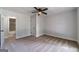 Neutral bedroom with carpet, a ceiling fan, and easy access to the en suite bathroom at 3404 Broxton Mill Way, Snellville, GA 30039