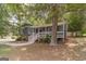 Exterior view of home featuring a porch, complemented by mature trees and a well-manicured lawn at 3404 Broxton Mill Way, Snellville, GA 30039
