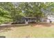 Lovely home featuring a covered front porch with mature trees providing shade at 3404 Broxton Mill Way, Snellville, GA 30039