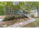 Charming split-level home with a covered porch and brick accents with mature landscaping at 3404 Broxton Mill Way, Snellville, GA 30039