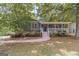Charming home with a covered front porch, well-maintained landscaping and mature trees at 3404 Broxton Mill Way, Snellville, GA 30039