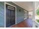 A front porch featuring wood flooring, siding, and a stylish black front door at 3404 Broxton Mill Way, Snellville, GA 30039