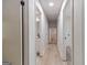 Neutral-toned hallway with hardwood flooring and views of the bathroom and bedrooms at 3404 Broxton Mill Way, Snellville, GA 30039