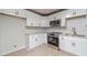 Bright kitchen showcases white cabinets, granite counters, stainless steel appliances, and modern finishes at 3404 Broxton Mill Way, Snellville, GA 30039