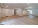 Open-concept living area with hardwood flooring and modern recessed lighting creating a bright and airy space at 3404 Broxton Mill Way, Snellville, GA 30039