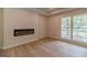 Living room showcasing a sleek fireplace and bright natural light with hardwood flooring at 3404 Broxton Mill Way, Snellville, GA 30039