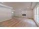 Bright, spacious living room featuring wood floors, recessed lighting, and a modern electric fireplace at 3404 Broxton Mill Way, Snellville, GA 30039