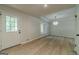 Bright living area with new hardwood floors, natural light, and stylish ceiling fixture at 3404 Broxton Mill Way, Snellville, GA 30039