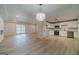 Open-concept living room and kitchen features hardwood floors, modern lighting, and updated appliances at 3404 Broxton Mill Way, Snellville, GA 30039