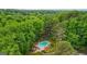 Aerial view of wooded community with lush greenery and large mature trees surrounding pool area at 1858 Preserve Way, Atlanta, GA 30341