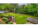 Expansive backyard featuring a fenced area, wooden steps, and lush greenery at 1858 Preserve Way, Atlanta, GA 30341