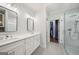 Bathroom featuring double sinks, modern vanity, glass shower, and gray tile floors at 1858 Preserve Way, Atlanta, GA 30341