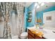 Bathroom featuring floral shower curtain, toilet, vanity, mirror, and decor creating a vibrant and functional space at 1858 Preserve Way, Atlanta, GA 30341