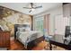 Bedroom featuring a map accent wall, ceiling fan, and a wooden desk at 1858 Preserve Way, Atlanta, GA 30341