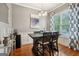 Dining room features hardwood floors, modern lighting, a large window and a decorative painting at 1858 Preserve Way, Atlanta, GA 30341