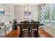 Dining room features hardwood floors, modern lighting, and a large window with patterned curtains at 1858 Preserve Way, Atlanta, GA 30341