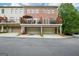 Exterior view showcasing the townhome's brick facade and private upper level deck at 1858 Preserve Way, Atlanta, GA 30341