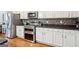 Modern kitchen featuring stainless steel appliances, granite countertops, and white cabinetry at 1858 Preserve Way, Atlanta, GA 30341