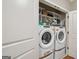 Convenient laundry room equipped with a washer and dryer, along with shelving for organized storage solutions at 1858 Preserve Way, Atlanta, GA 30341