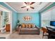 Living room with sofa, desk, and a view into an adjacent bathroom, showcasing its comfortable and inviting ambiance at 1858 Preserve Way, Atlanta, GA 30341