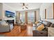 Inviting living room with hardwood floors, a fireplace, and plenty of natural light from the windows at 1858 Preserve Way, Atlanta, GA 30341