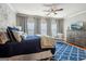 Main bedroom featuring a blue accent rug, TV, and windows with light-blocking curtains at 1858 Preserve Way, Atlanta, GA 30341