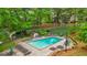 Community pool area surrounded by lounge chairs and lush landscaping for residents at 1858 Preserve Way, Atlanta, GA 30341