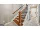 Staircase featuring wood steps, wrought iron spindles, and access to the front door at 1858 Preserve Way, Atlanta, GA 30341