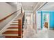 Staircase with hardwood steps and railing, showcasing a well-lit hallway and doorway to a brightly colored room at 1858 Preserve Way, Atlanta, GA 30341
