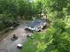 Aerial view of house and property showing the driveway, surrounding landscape, and parked cars at 6290 Cascade Palmetto Hwy, Fairburn, GA 30213