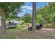 Beautiful backyard surrounded by lush greenery, featuring a trampoline and plenty of space to enjoy the outdoors at 6290 Cascade Palmetto Hwy, Fairburn, GA 30213