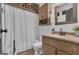 Charming bathroom featuring a wood vanity, framed mirror and decorative metal wall decor at 6290 Cascade Palmetto Hwy, Fairburn, GA 30213