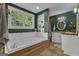 Stylish bathroom featuring a soaking tub, wood floors, natural lighting, and a wood countertop sink at 6290 Cascade Palmetto Hwy, Fairburn, GA 30213